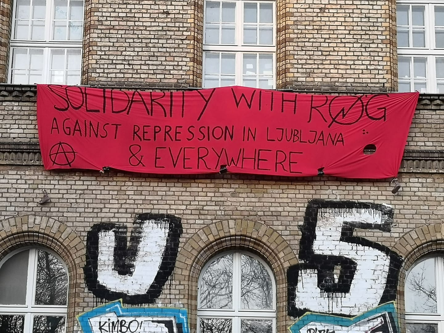 house with demonstration banner